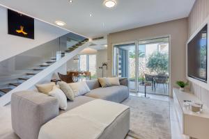 a living room with a couch and a staircase at Villa Rosciola in Crikvenica