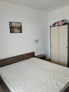 a bedroom with a white bed and a cabinet at 2 Room Apartment Costa Calma Aheloy Bulgarien in Aheloy +26 photos