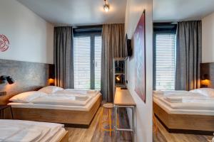 Postel nebo postele na pokoji v ubytování MEININGER Hotel Berlin Tiergarten