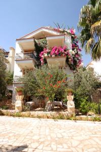 a building with flowers on the side of it at Diana Aparts in Kalkan