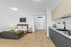 a large bedroom with a bed and a kitchen at One SeaView std in Infinity Pool & Spa Resort in Mamaia Sat/Năvodari