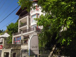 a building with a sign in front of it at Roberto Hotel in Sinaia +99 photos