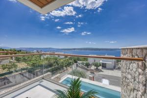 a view from the balcony of a house with a swimming pool at Villa Rosciola in Crikvenica