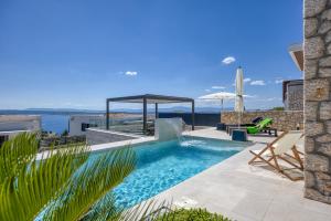 a swimming pool with a view of the ocean at Villa Rosciola in Crikvenica