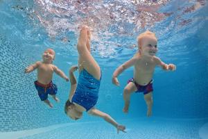 three children swimming in the water in the pool at 6 Berth Caravan With Decking At Caister Haven Holiday Park Ref 30032P in Great Yarmouth
