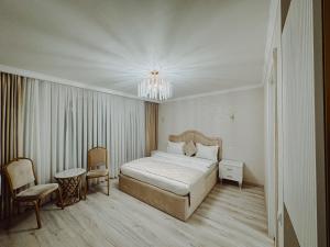 a bedroom with a bed and a chandelier at Yerevan In Boutique Hotel in Yerevan +59 photos