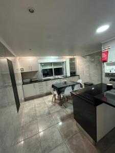 a large kitchen with a table and chairs in it at Apartment in Palmela - Close to Beaches and Mountains! in Palmela