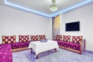 a living room with a couch and a table at White Majorelle Casa Grande in Tamraght Ouzdar