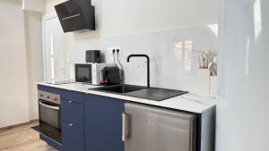 a kitchen with a sink and a stove at COCON Mayennais - Loft Balnéo Laval - Loveroom in Laval +16 photos