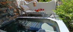 a koi pond in a garden with a bench at Aliori art caves in Aegiali