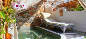 a bench sitting next to a pool of water at Aliori art caves in Aegiali