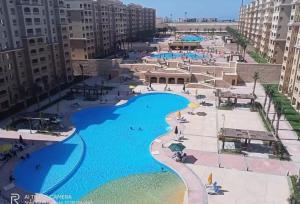 an aerial view of a resort with a large swimming pool at Aqua View Studio in Dawwār Abū Maḩrūs