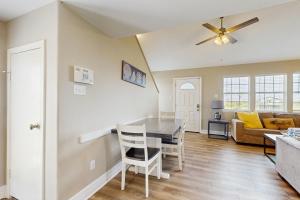 a dining room and living room with a table and chairs at Sunset Palms in Galveston