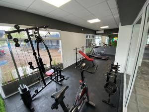 a gym with several treadmills and exercise bikes at ACA Villa Bordeu in Bahía Blanca