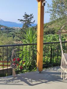 a porch with a swing and a fence at Georgia's Dream House in Koprána +59 photos