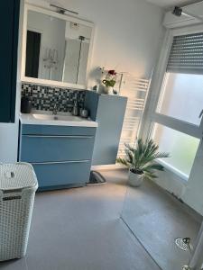 a bathroom with a sink and a mirror at Douce Escapade Sud 7 pers Wi-Fi parking gratuit in Grabels
