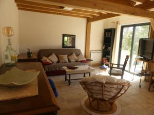 a living room with a couch and a tv at La Férandie in Chéronnac