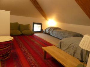 a living room with two beds and a couch at La Férandie in Chéronnac