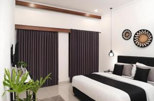 a bedroom with a large bed and a large window at Villa Mimoza Umalas Bali in Kerobokan +9 photos