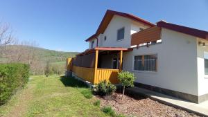 a house with a yellow fence on the side of it at Borovilla in Kismaros
