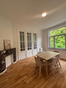 a dining room with a table and a fireplace at Sacré-Coeur Brussels 2 in Brussels