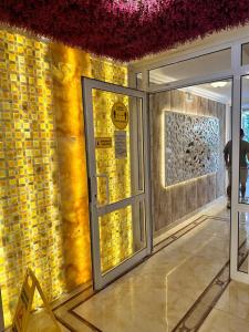 a lobby with a door and a yellow wall at Sweet Homes in Sunny Beach +15 photos