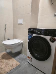 a washing machine in a bathroom with a toilet at Apartman Dioniz Fojnica in Fojnica +22 photos