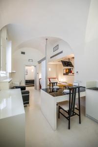 a kitchen and living room with a table and chairs at Mini-loft just steps from the Duomo of Modena in Modena