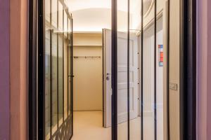 a hallway with glass doors in a building at Mini-loft just steps from the Duomo of Modena in Modena