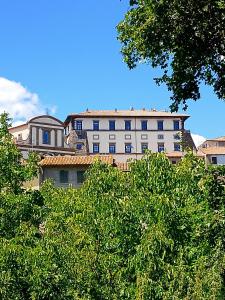 a large white building with trees in front of it at Al Poggetto in Gradoli
