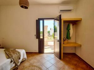 a room with a door open to a room with a bed at La Cupola di Casa Camilla Journey in Tricase