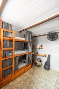 a room with two bunk beds in a room at Rota Itacaré Surf Hostel in Itacaré
