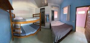 a small room with two bunk beds in it at Rota Itacaré Surf Hostel in Itacaré +20 photos