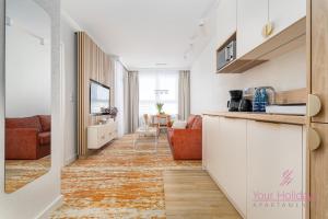 a hallway with a kitchen and a living room at Your Holidays Bel Mare Aqua F203 in Międzyzdroje
