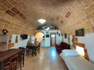 a living room with a couch and a table at Il Campanile di Casa Camilla Journey in Tiggiano