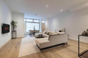 a living room with a couch and a table at Charming Stay De Pijp at Centrum in Amsterdam