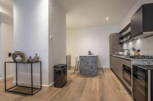 a kitchen with a counter and a table in it at Charming Stay De Pijp at Centrum in Amsterdam +17 photos