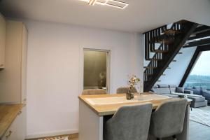 a kitchen with a dining table and a living room at Chalet Palma in Ciumîrna +2 photos