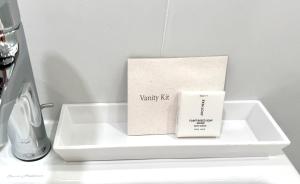 a white tray with a candle and a box on it at Wainscott Woods Retreat in Wainscott +28 photos