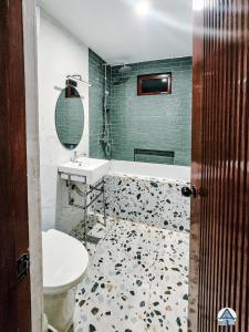 a bathroom with a sink and a toilet at Avas Blue Tagaytay Vacation House with Pool in Kaybagal
