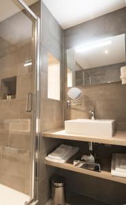a bathroom with a sink and a shower at Hotel De Zoete Inval Haarlemmerliede in Haarlem