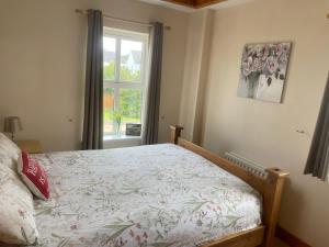 a bedroom with a bed and a window at Portstewart Escape in Portstewart