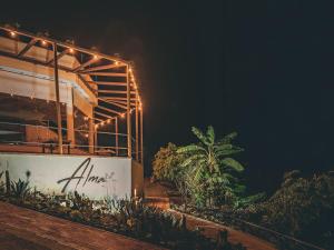 a building with lights on it at night at Hotel Alma in Tinjacá