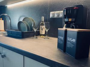 a kitchen counter with wine glasses and a coffee maker at Villa Maria Petru in Ierissos +64 photos