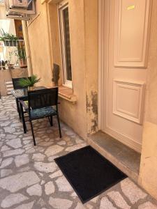 a chair and a table in front of a door at Chez Isa, Les pieds dans l'eau in Valras-Plage +13 photos