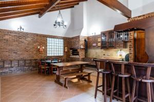 a large kitchen with a wooden table and chairs at Rosa Casa Jardim da Serra in Canela