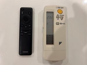 a nintendo wii controller next to a remote control at Vinhomes Grand Park Homestay-The Beverly Hills in Long Bình