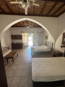 a large room with two beds and an arched ceiling at Karpaz Arch House Hotel in Rizokarpaso