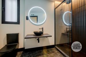 un baño con lavabo y espejo en Un Madrid moderno para 7, tu refugio en Abada 2 E2, en Madrid 27 fotos más