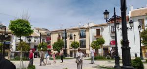 a group of people walking down a street at A Beautiful Townhouse in Rute